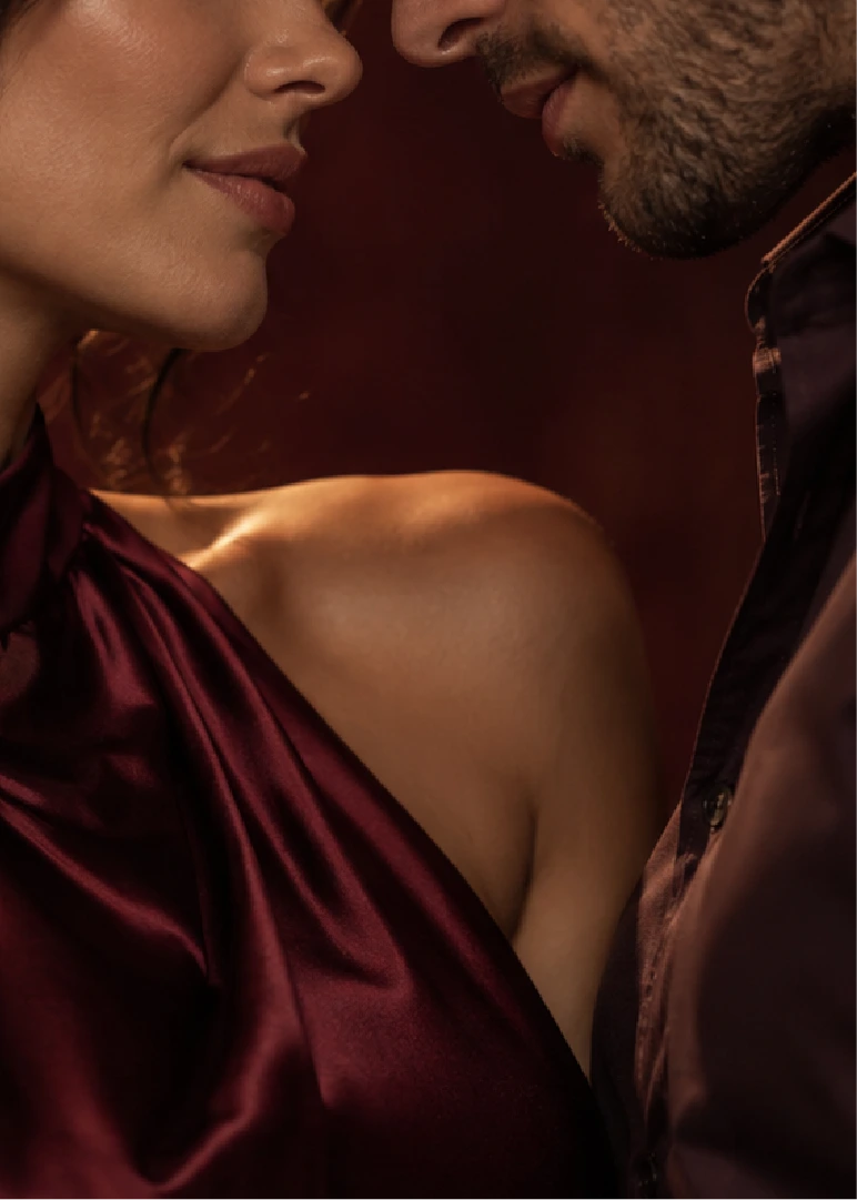 A couple about to kiss, in warm wine tones